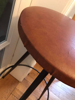 Élégant tabouret de bar, assise ronde au revêtement d’origine Skaï couleur cuir, piétement trépied en métal, dans son jus, dimensions : diamètre assise 33 cm, diamètre repose-pied 36 cm, H 75 cm.