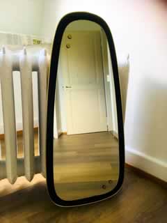 Miroir rétro asymétrique, bordure plastique doré, H 83cm, l max 38,5cm.