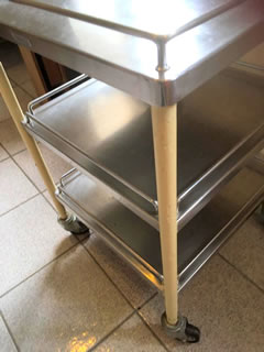Desserte style industriel, meuble de métier, structure en métal montée sur 4 roulettes et soutenant 3 plateaux; tubes verticaux peints d’origine avec quelques manques par endroits; dimensions: H 78 cm, 50 cm de côté.