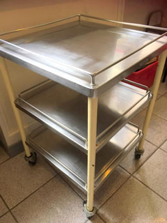Desserte style industriel, meuble de métier, structure en métal montée sur 4 roulettes et soutenant 3 plateaux; tubes verticaux peints d’origine avec quelques manques par endroits; dimensions: H 78 cm, 50 cm de côté.