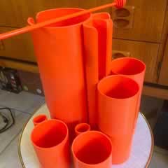 Service à orangeade, attribué à JP Vitrac, made in France, design très seventies , composé d’un pichet, de 6 verres et d’un agitateur ( à l’origine set de 2 agitateurs), en matière plastique de couleur orange, pichet : H 26, diam 10; verre: H 9, diam 6,5.